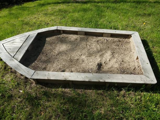istock wood boat filled with sand on green grass 1168774519