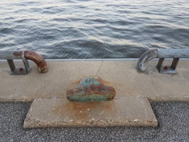 istock cement and metal railing and boat tie with water 1168775130