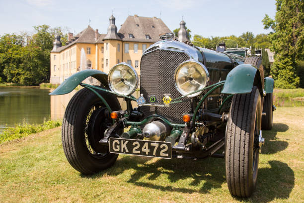 Front view of a rare 1929 Bentley Super Six in a park with castle backdrop. Jüchen, Germany - August 2019. Front view of a rare 1929 Bentley Super Six in the surrounding public park of Schloss Dyck castle in Jüchen, Germany. 1920 1929 stock pictures, royalty-free photos & images