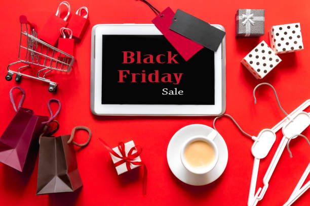 istock Creative top view flat lay online shopping tablet, trolley with packages, gift boxes. Concept of e-commerce, black friday, discounts, sales, christmas shopping on red background. 1168776208