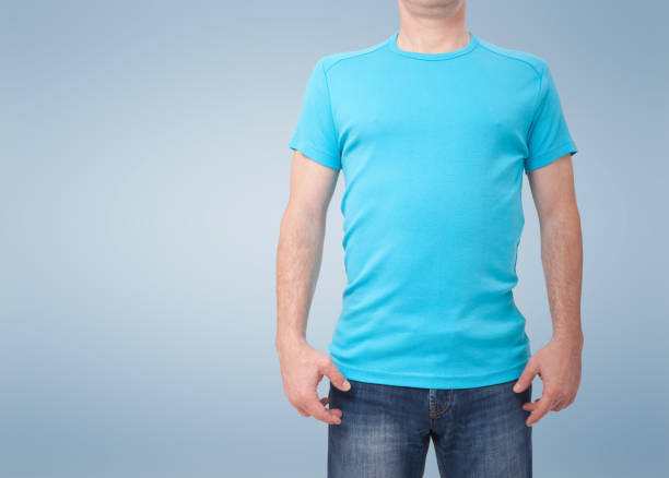 istock Man wearing blank blue t-shirt isolated on white background with copy space. Tshirt design and people concept - close up of men in blank shirt. For mock up template design. Front view 1168776397