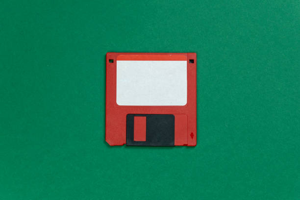 istock red floppy disk on green background. retro magnetic storage 1168776617