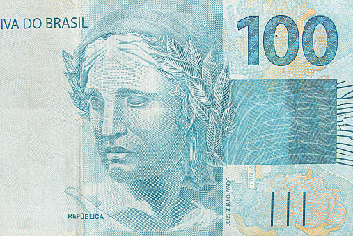 Brazilian hundred real banknote. Blue note, 100 reais brl. Brazilian money, real note. Macro photo.