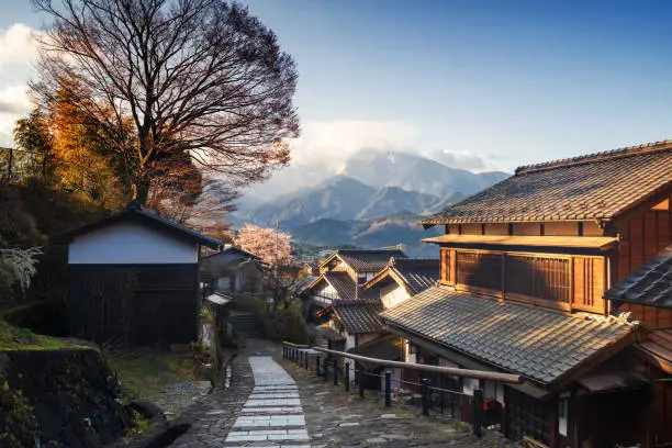 Magome juku post town of Nakasendo with central alps mountain at sunrise during spring, Kiso valley in  Nakatsugawa, Gifu Prefecture, Japan. Famous travel landmark of preserved  old Japanese town.