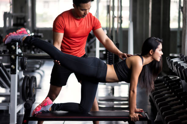 istock Woman stretch back and leg with trainer 1168777723