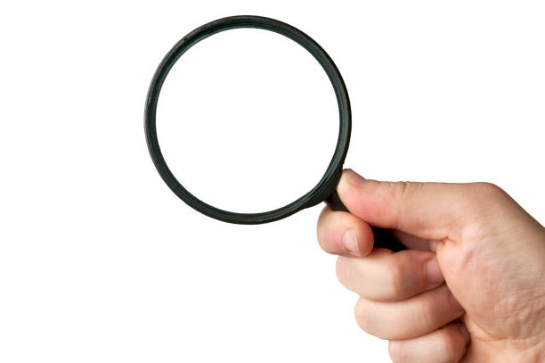 istock Man hold a magnifying glass on white background 1168780490