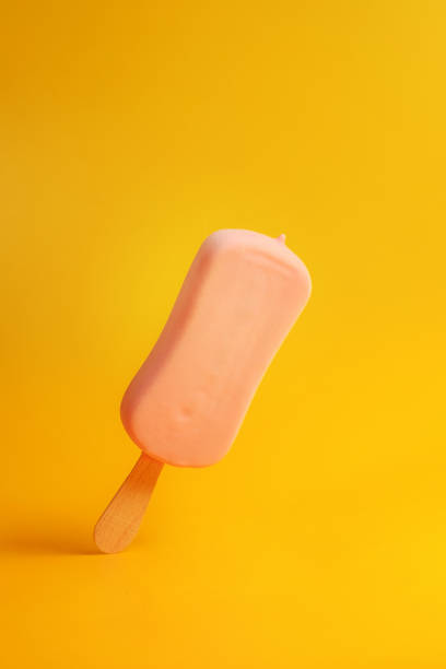 istock pink ice cream popsicle on yellow background 1168781229
