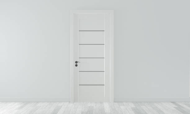 istock mock up door on empty room white wall on white wooden floor.3D rendering 1168782064