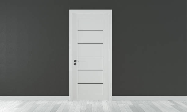 istock mock up door on empty room black wall on white wooden floor.3D rendering 1168782745