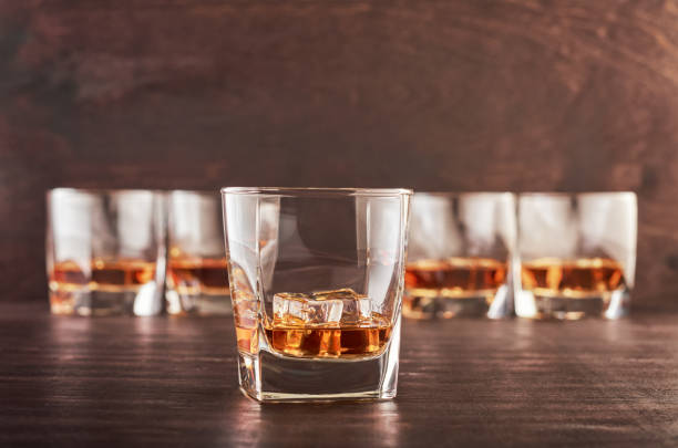 istock Glass of whiskey on a wooden table 1168782911