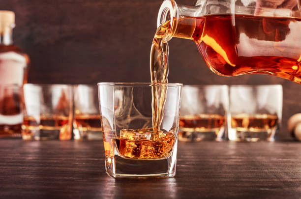 istock Glass of whiskey on a wooden table 1168782933