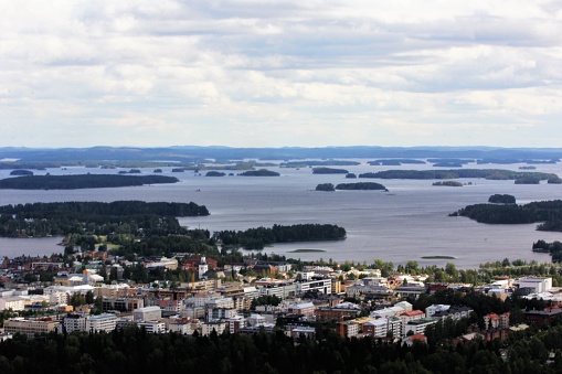 Kuopio seen from outside and above. In the background the lake with dozens of small islands.