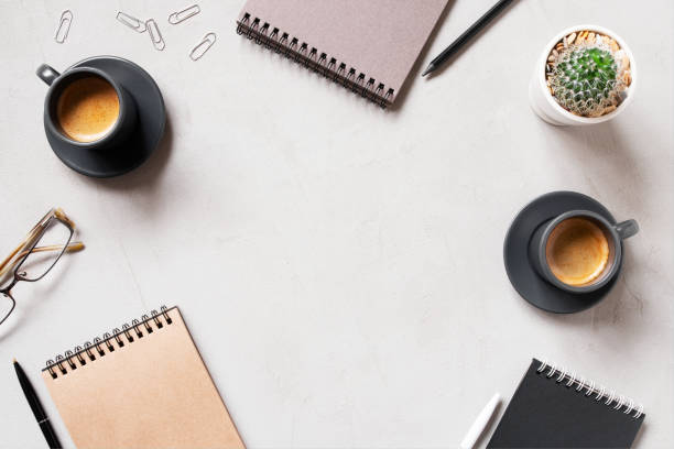 istock Office background with two cups of coffee espresso and open notepads 1168784195