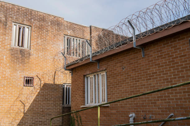 Coiled barbed wire on the roof of a prison.