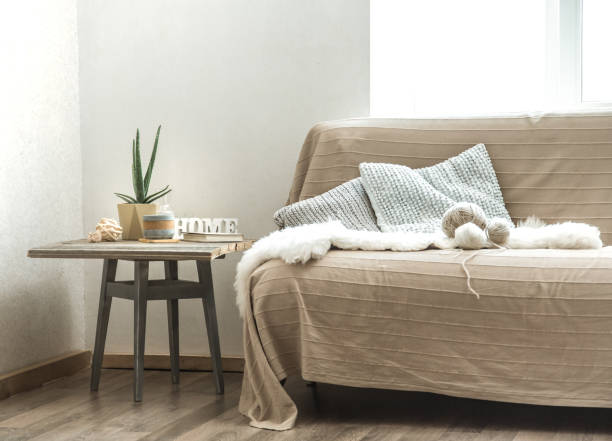 istock Home sofa with objects of cozy decor in the living room 1168788269