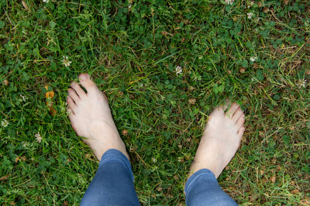 istock Female feet on the grass 1168789382