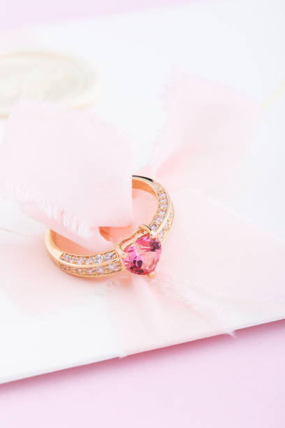 istock Golden engagement ring with pink heart shaped gemstone 1168790674