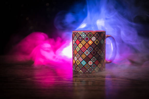 istock Beautiful eastern style textured ceramic cup of coffee (or tea) with smoke over dark toned background. 1168796633