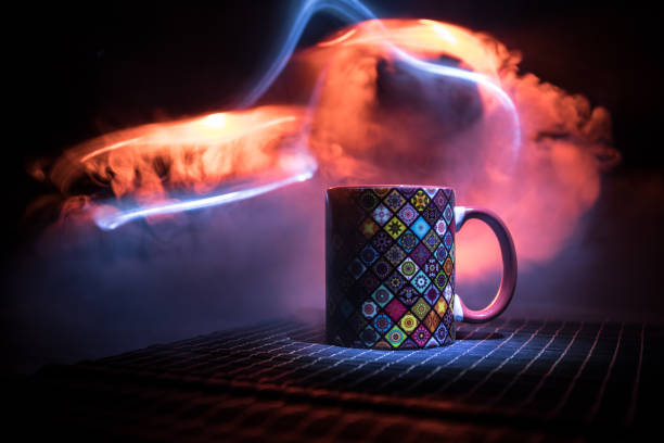 istock Beautiful eastern style textured ceramic cup of coffee (or tea) with smoke over dark toned background. 1168796647