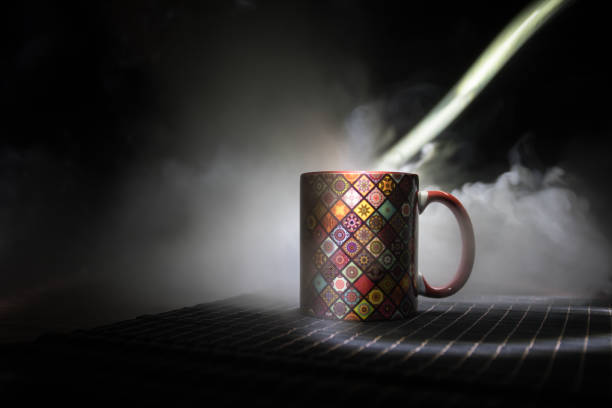 istock Beautiful eastern style textured ceramic cup of coffee (or tea) with smoke over dark toned background. 1168796656
