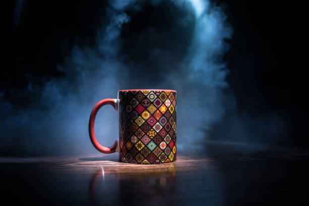 istock Beautiful eastern style textured ceramic cup of coffee (or tea) with smoke over dark toned background. 1168796661