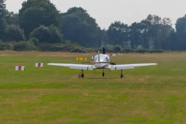 Photo of a landing  plane on a small airfield