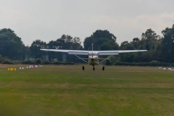 Photo of a landing  plane on a small airfield