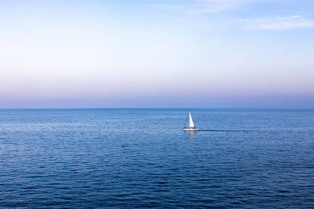 istock Lonely sailboat sailing at sunset on the Mediterranean 1168798085