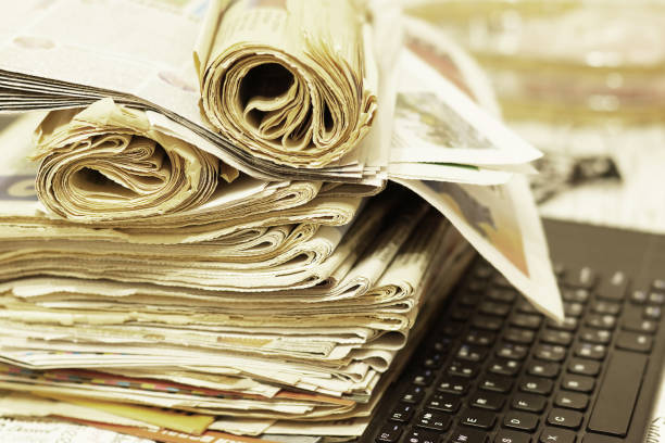 istock Pile of Newspapers and Computer Keyboard 1168799212