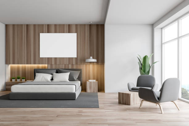 istock White and wood bedroom interior, poster, armchairs 1168805996