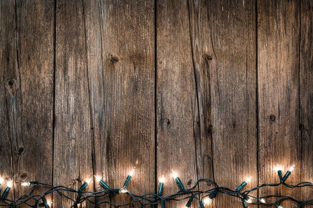 istock Empty rustic wooden table with Christmas lights at the bottom border 1168806105