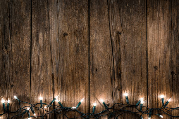 istock Empty rustic wooden table with Christmas lights at the bottom border 1168806183