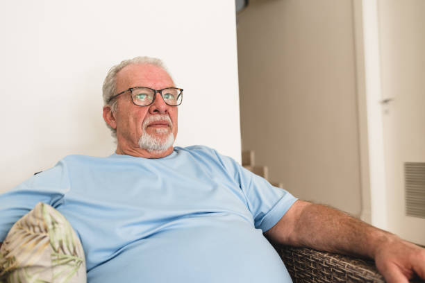 istock Senior man in armchair at home 1168807480