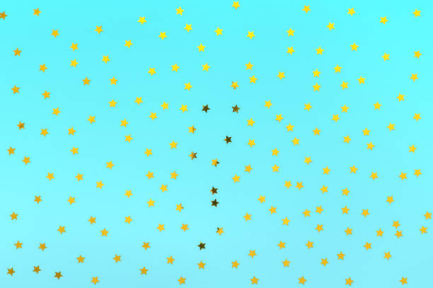 istock Gold stars sprinkles on pastel blue backdrop. Festive holiday background. for your projects. Celebration concept. Christmas pattern. Top view, flat lay 1168808057