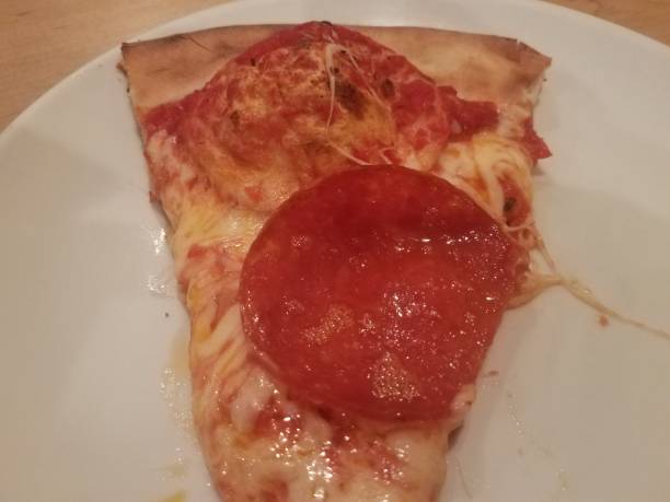 istock slice of pepperoni pizza with large pepperoni on plate 1168818681