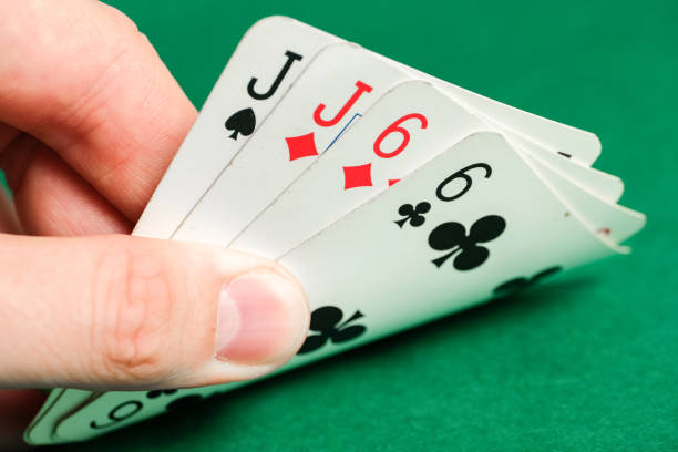 istock Hand holds a combination in poker - two pair on a green background. 1168824348
