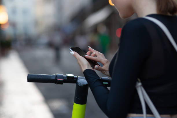 istock A woman using a mobile phone for unlocking an electric scooter by app 1168825590