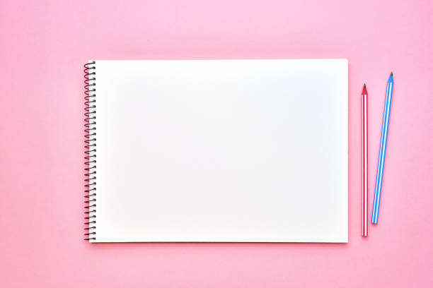 istock Spiral notepad with pencils. Notebook on pastel pink backdrop. Back to school concept. Copy space, top view. 1168828992