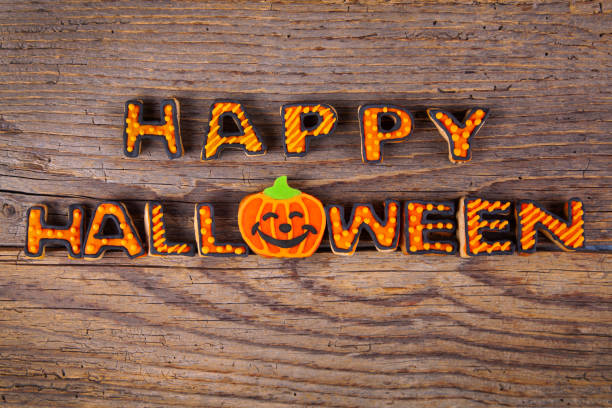 istock Happy Halloween with gingerbread handmade cookies on rustic wooden table 1168830493