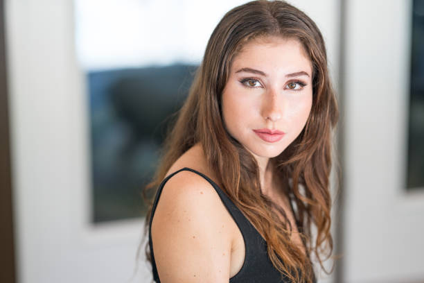 istock Beautiful young brunette looking at camera 1168832415