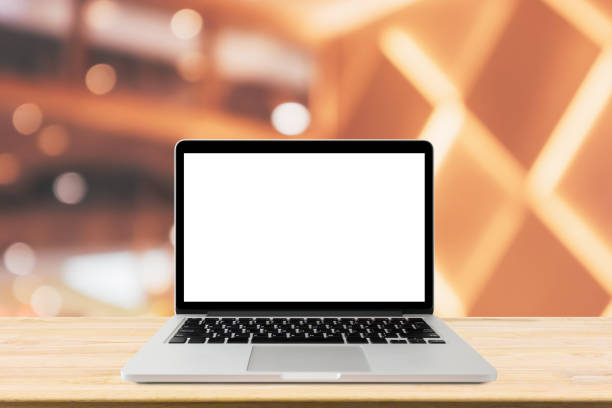 istock Blank screen laptop computer on wood table top with blur cafe restaurant with abstract bokeh light defocused background 1168839934