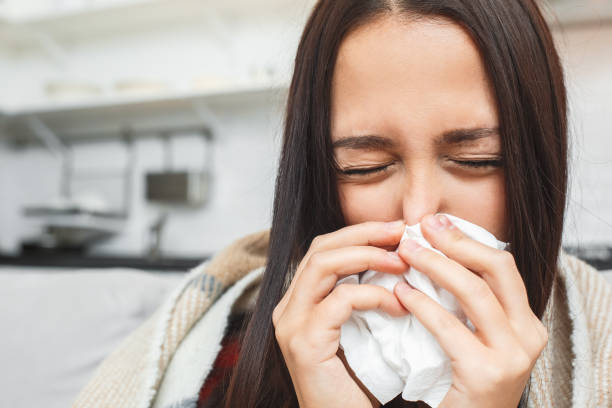 istock Young couple having evening at home girlfriend close-up sneezing 1168840677