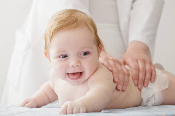 istock nurse does massage to baby 1168841359