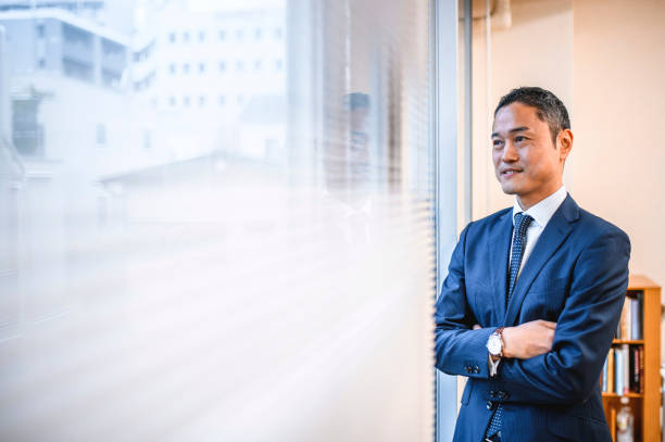 istock Confident Japanese Hospital Administrator Looking out Window 1168842161