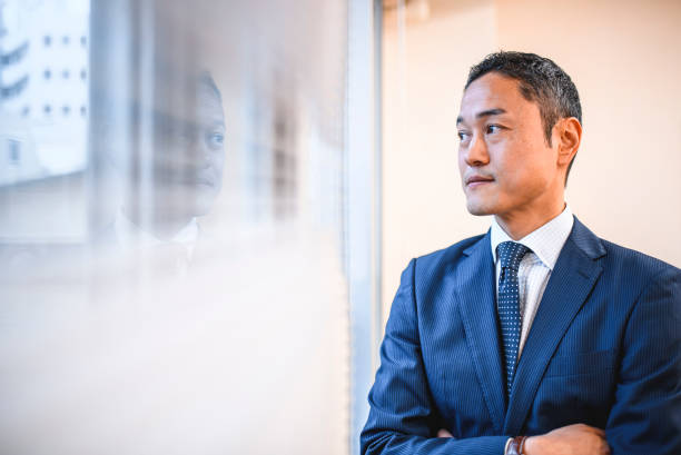 istock Serious Japanese Hospital Administrator Looking out Window 1168842176