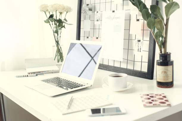 istock Freelance workspace laptop on a desk no people side view close-up 1168842480