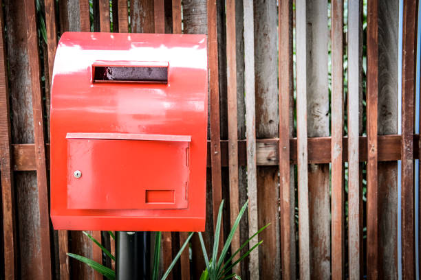 istock red post box beside wooden fence 1168842658