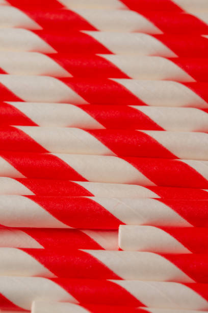 istock Background from red-white tubules for soda, close-up, macro, vertical frame 1168843421