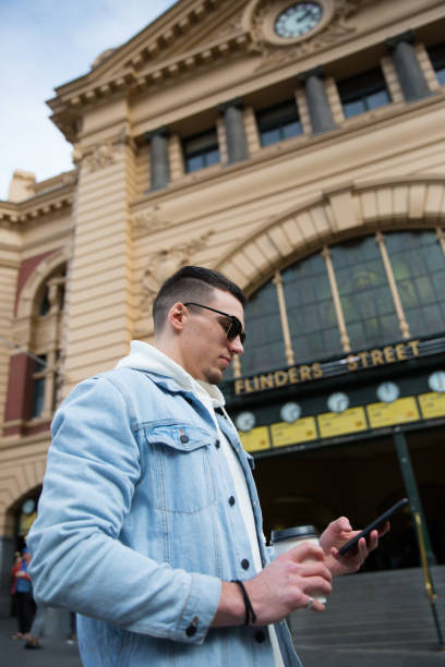 istock Man Texting in Front of Flinders Street Station 1168847619
