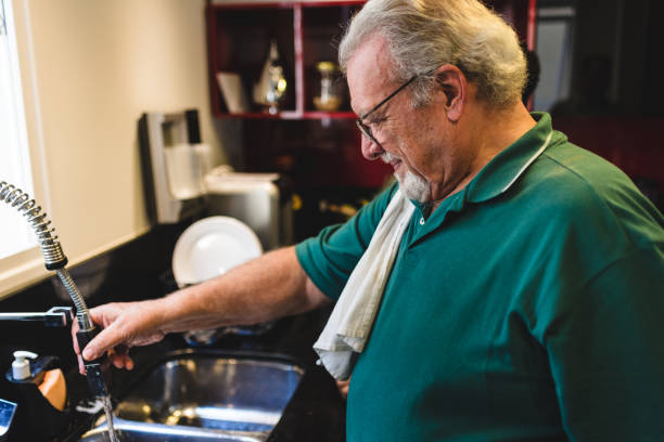 istock Senior Man Finishing Cleaning Kitchen Sink 1168847823